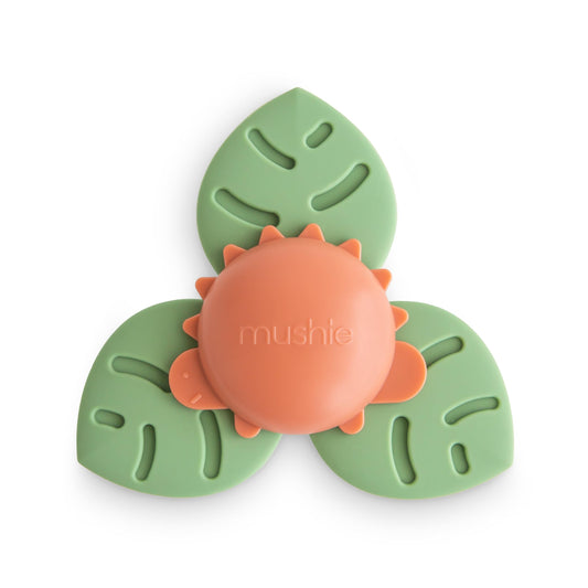 Mushie Dino Suction Spinner Toy spins during bath time for sensory play