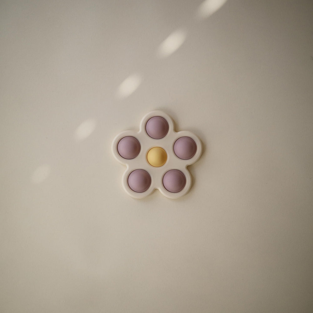 Mushie Flower Press Toy daffodil bubble closeup highlighting color play