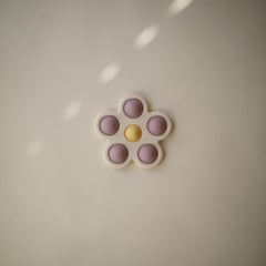 Mushie Flower Press Toy daffodil bubble closeup highlighting color play