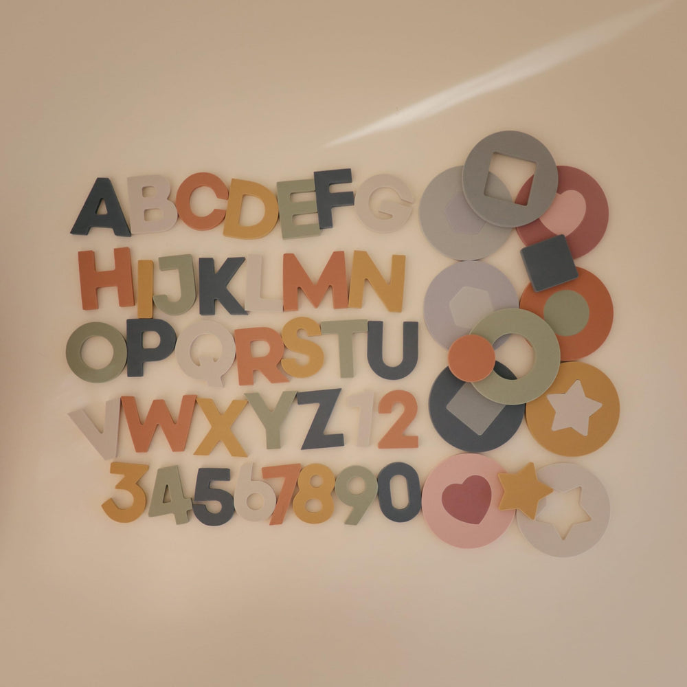 Mushie bath puzzle pieces stick to surfaces for interactive tub play