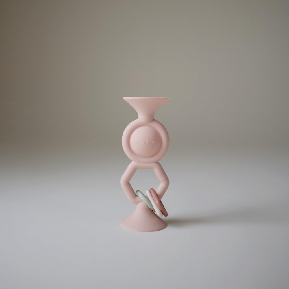Mushie HexaPop bottom suction cups secure play during meals or travel.