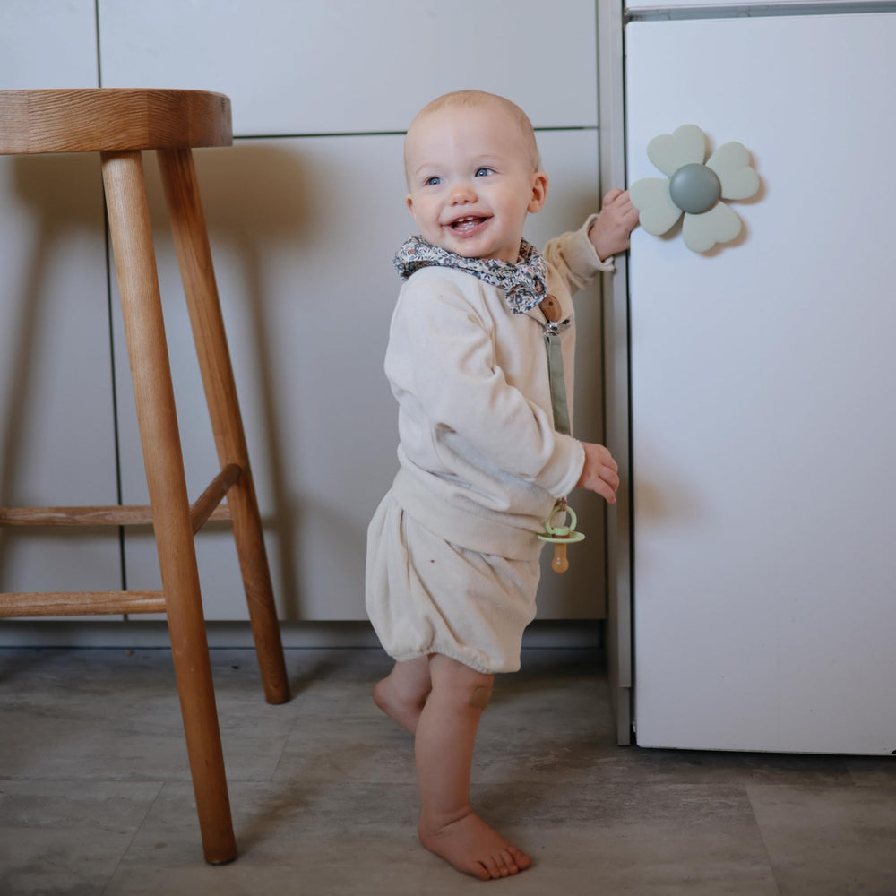 Mushie Lucky Suction Spinner Toy clings to cabinet door for quick fun.