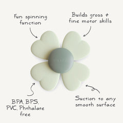Mushie Lucky Suction Spinner Toy with leaves spins around the dinosaur.
