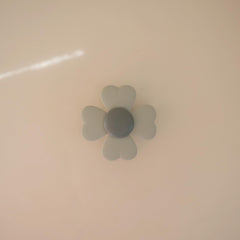 Mushie Lucky Suction Spinner Toy sticks to highchair for mess-free play.