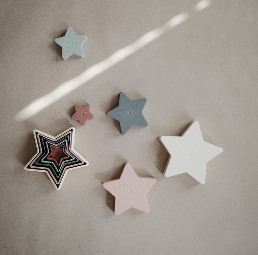 Mushie Nesting Stars Toy soft colors aid color recognition and stacking.