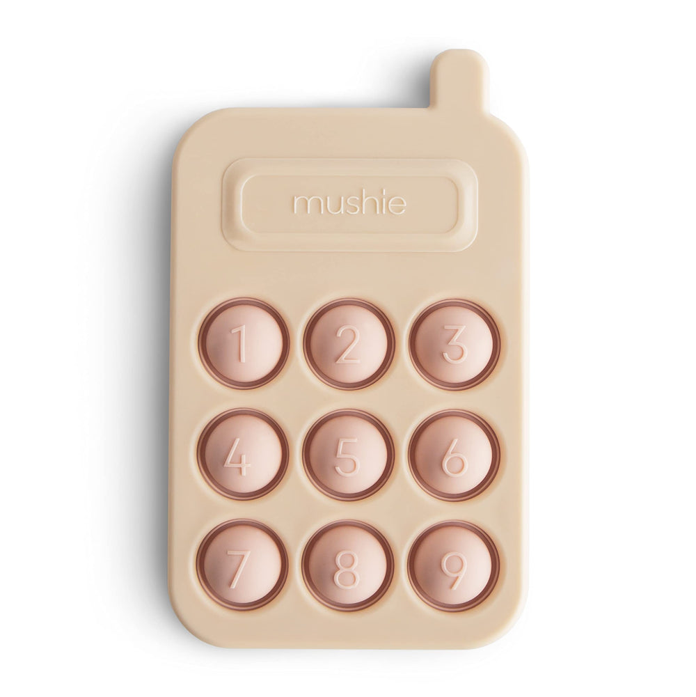 Mushie Phone Press Toy Blush close-up with popping bubbles for fine motor play