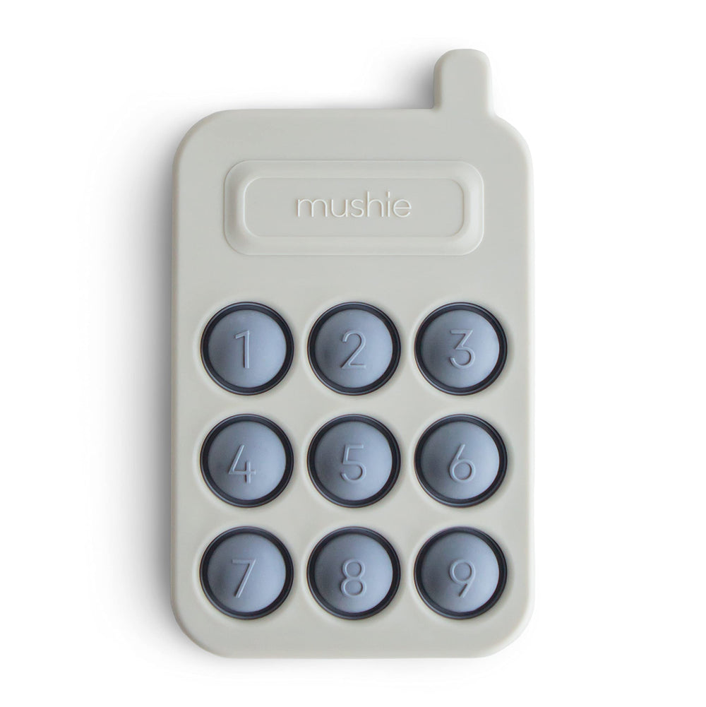 Mushie Phone Press Toy Tradewinds with popping bubbles for sensory exploration.