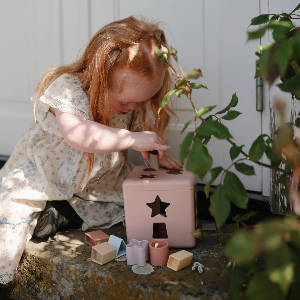 Mushie Shape Sorting Box Petal close-up shapes show tactile edges