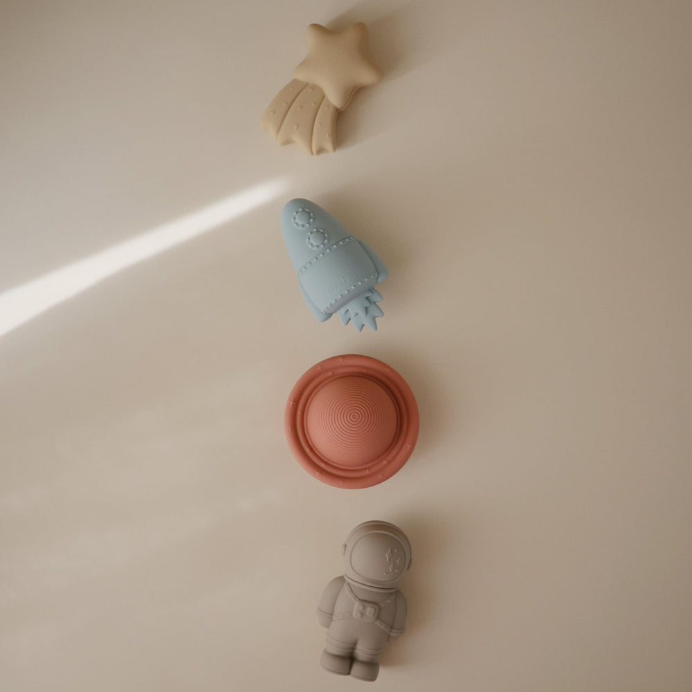 Mushie Space Bath Rocket, bright toy inspires imaginative bathtub adventures.