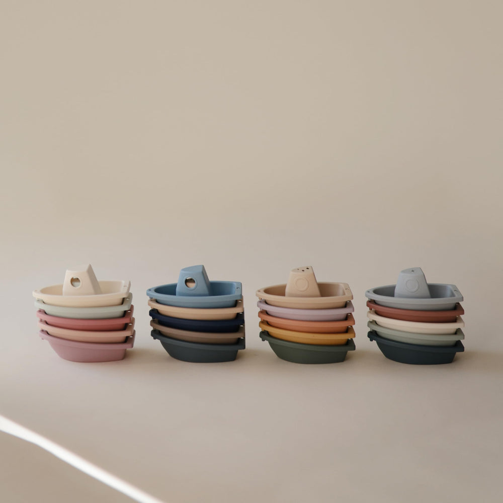 Floating boats create a playful backdrop for bath storytelling.