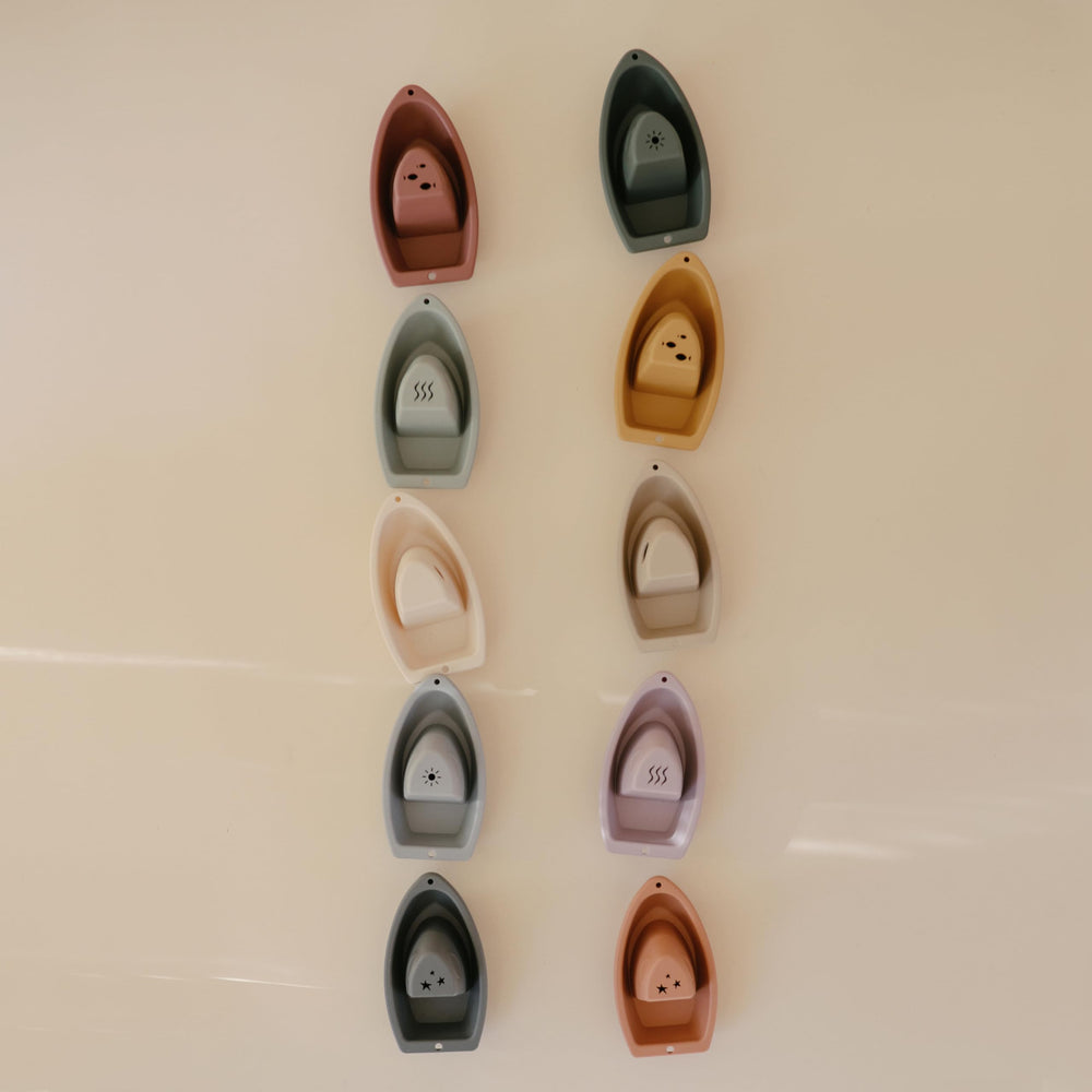 Mushie Stackable Bath Boats Train Assembly 02 demonstrates color awareness and early counting.