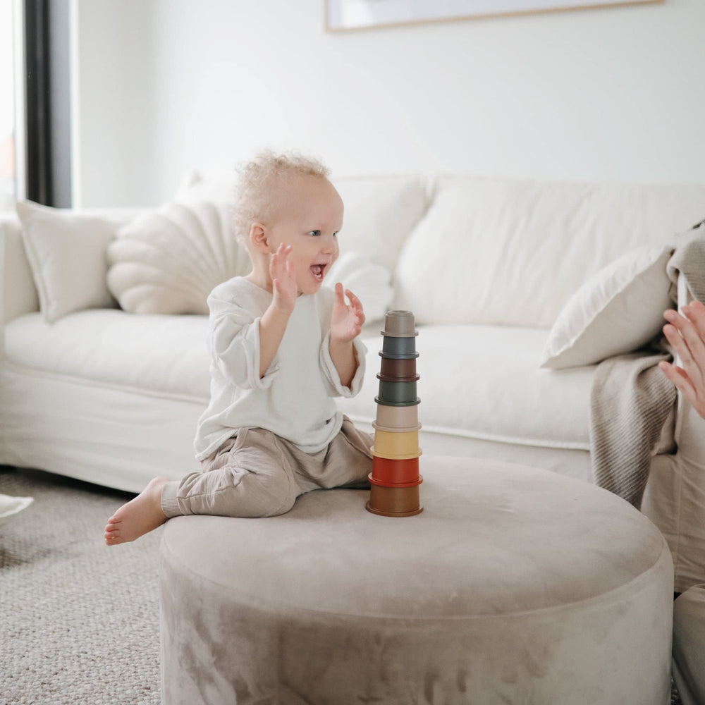 Mushie Stacking Cups Toy pieces dispersed shows open-ended play possibilities