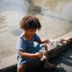 Mushie Water Wheel Bath Toy child playing encourages hands-on bath engagement