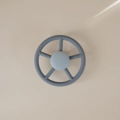 Mushie suction spinner on airplane tray for compact, engaging travel play