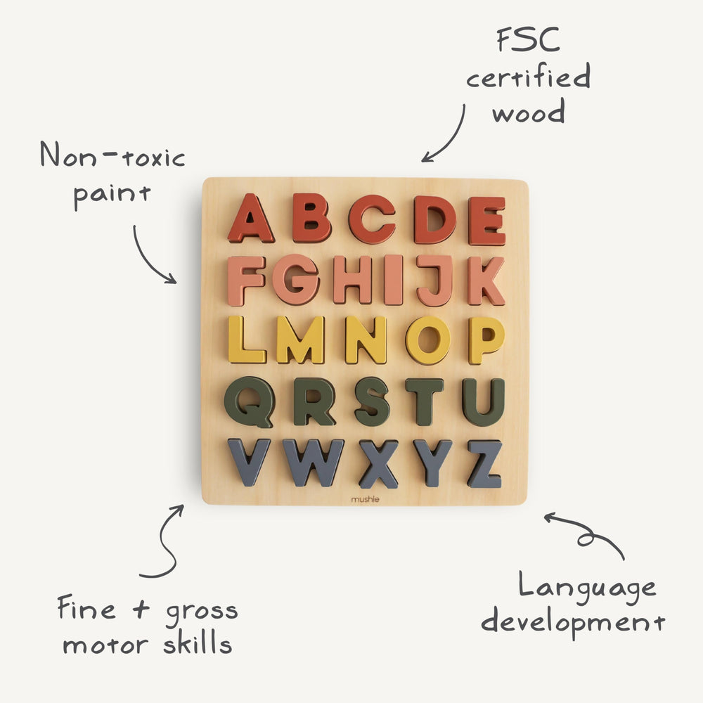 Mushie wooden alphabet puzzle letters in slots for hands-on matching.