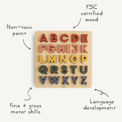 Mushie wooden alphabet puzzle letters in slots for hands-on matching.
