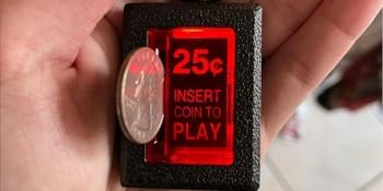 New Wave Toys RepliCade LED coin return button keychain glows to amuse.