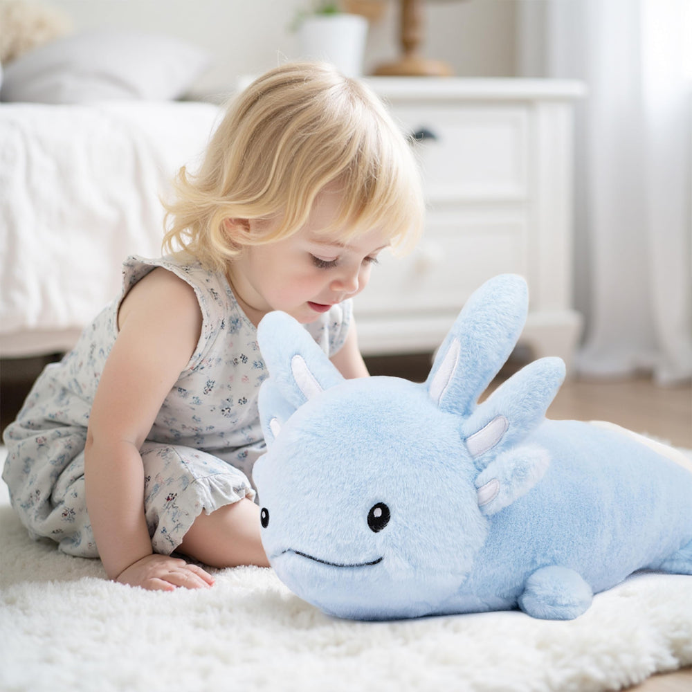Niuniu Daddy blue axolotl plush resting beside a child during bedtime.