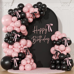 NuttyBash pink and black balloon arch kit setup creates a chic coquette backdrop.