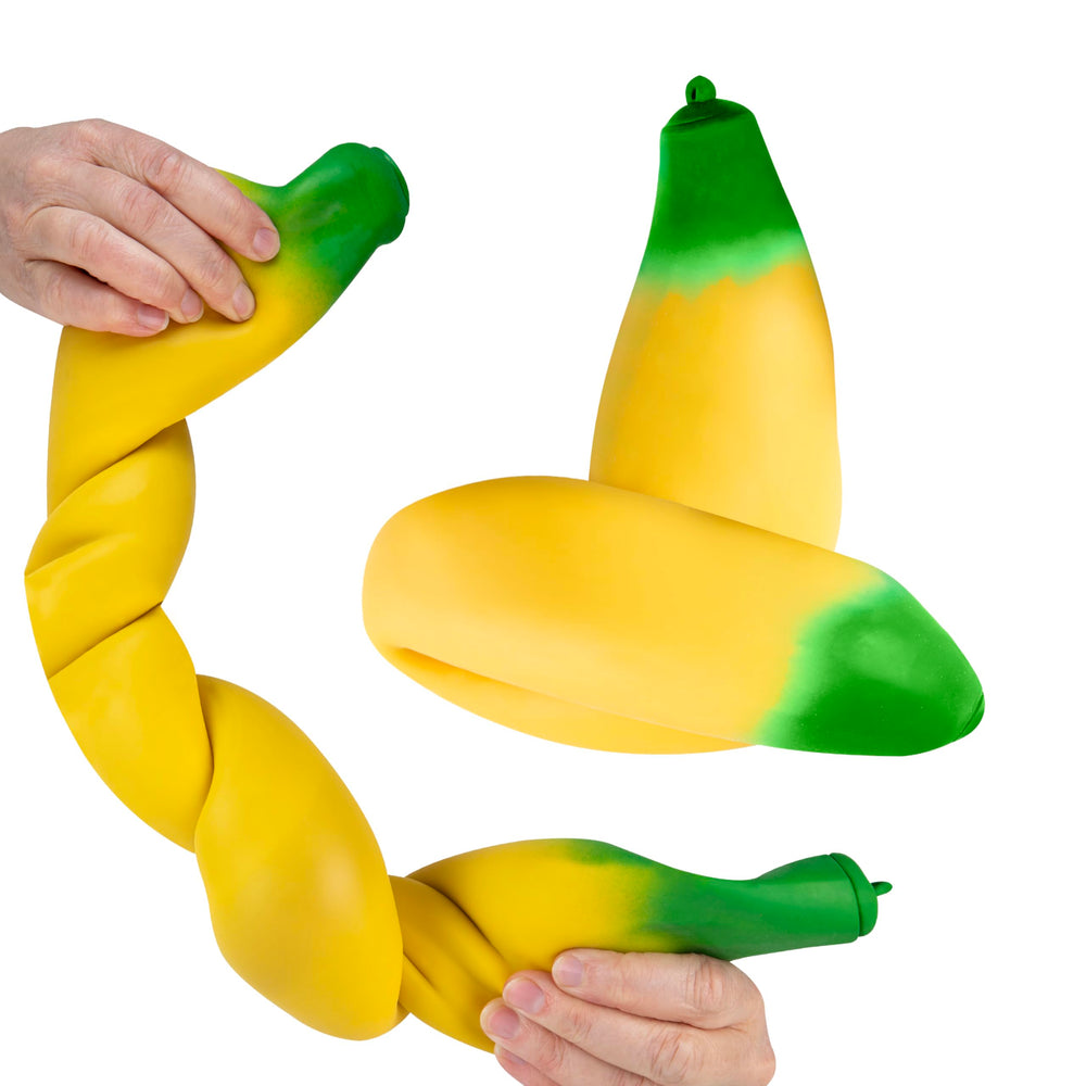 The Orb Factory Easy Sqweezy Giant Stretchy Banana on desk, a fun fidget toy and conversation starter
