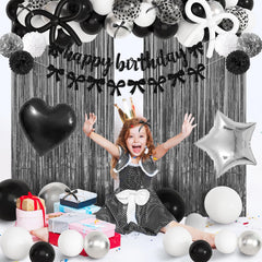Ouddy Party black bow decor balloons coordinate a cohesive look.