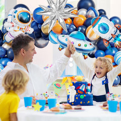 Navy blue and orange balloons provide bold color contrast for space vibe