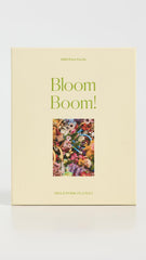 Piecework Bloom Boom assembled puzzle on table showcases a rainbow of petals, perfect for framing