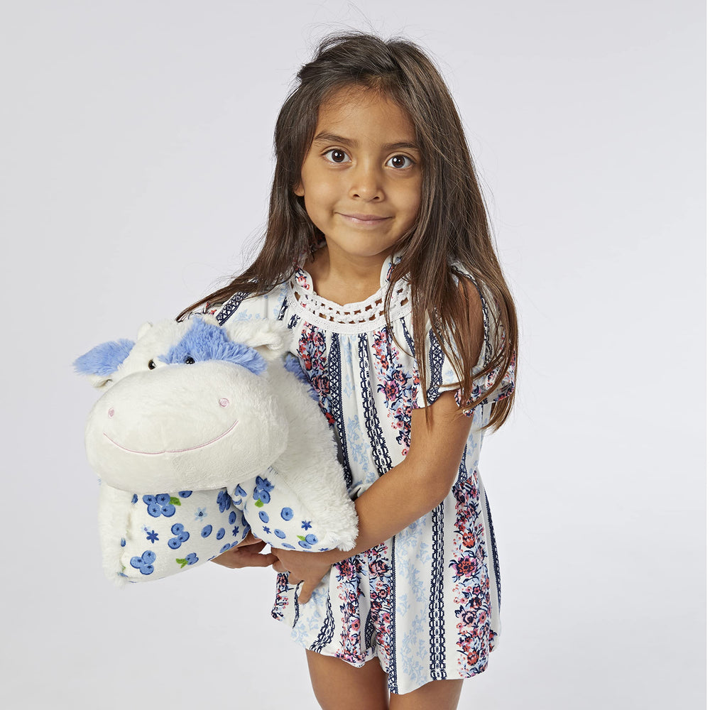 Pillow Pets Blueberry Cow snuggling with a child, comforting bedtime companion