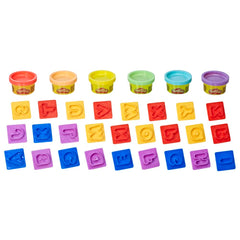 Play-Doh Fundamentals alphabet practice stampers in use for letter familiarity.
