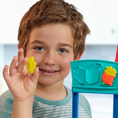 Play-Doh Kitchen Creations Busy Chef's Restaurant Playset menu board supports daily specials during play.
