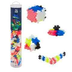 PLUS PLUS glow-in-the-dark blocks arranged in a tube for night-time play
