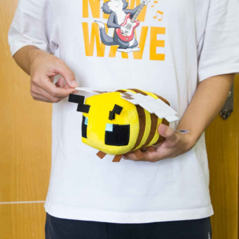 Putrer Bee plush on bed as cute decor and cuddle companion.