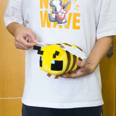 Putrer Bee plush on bed as cute decor and cuddle companion.