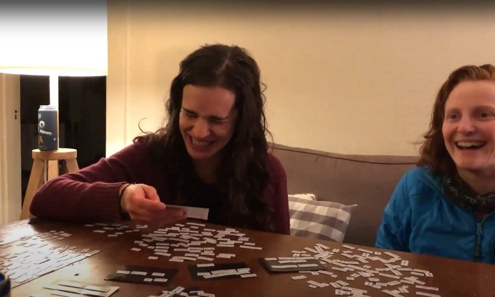 Ransom Notes game-night setup shows friends laughing while crafting sentences.