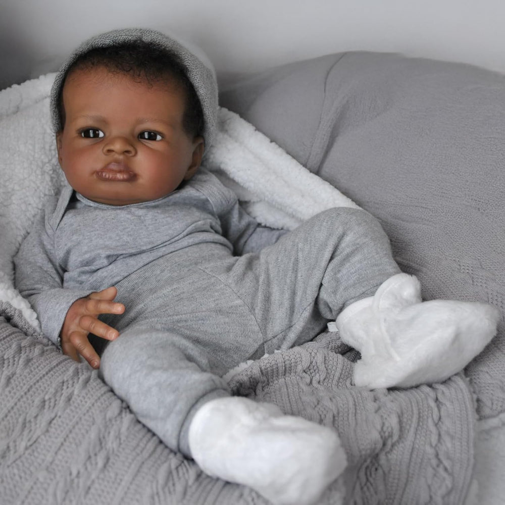 Realistic Black Boy 20-inch doll eyes convey expressive, lifelike gaze for nurturing play.