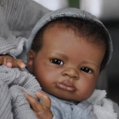 Realistic Black Boy 20-inch package includes suit, pacifier, bottle, diaper, and birth certificate.