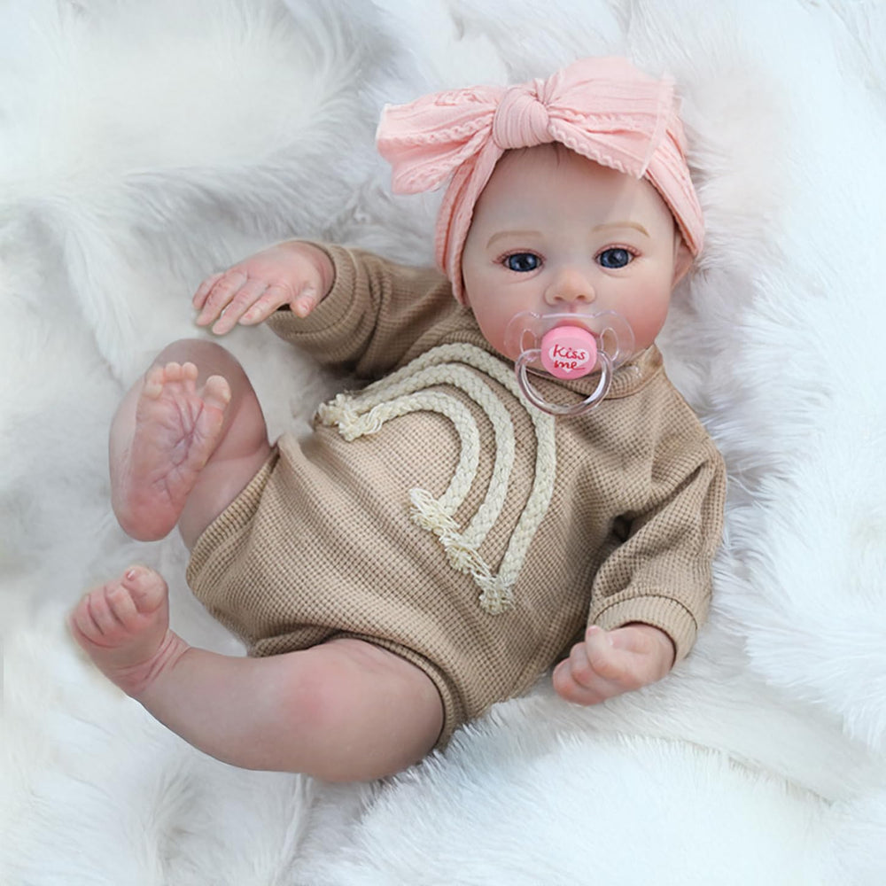 Reborn Baby Dolls Girl includes a magnetic pacifier for soothing pretend care.