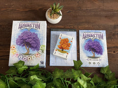 Renegade Arboretum players discussing turns while shaping a beautiful garden.