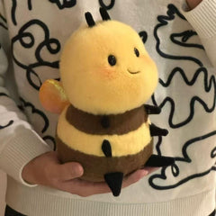RHHSSE Chubby Smiling Bee Plush on bed adds cozy decor and companionship.