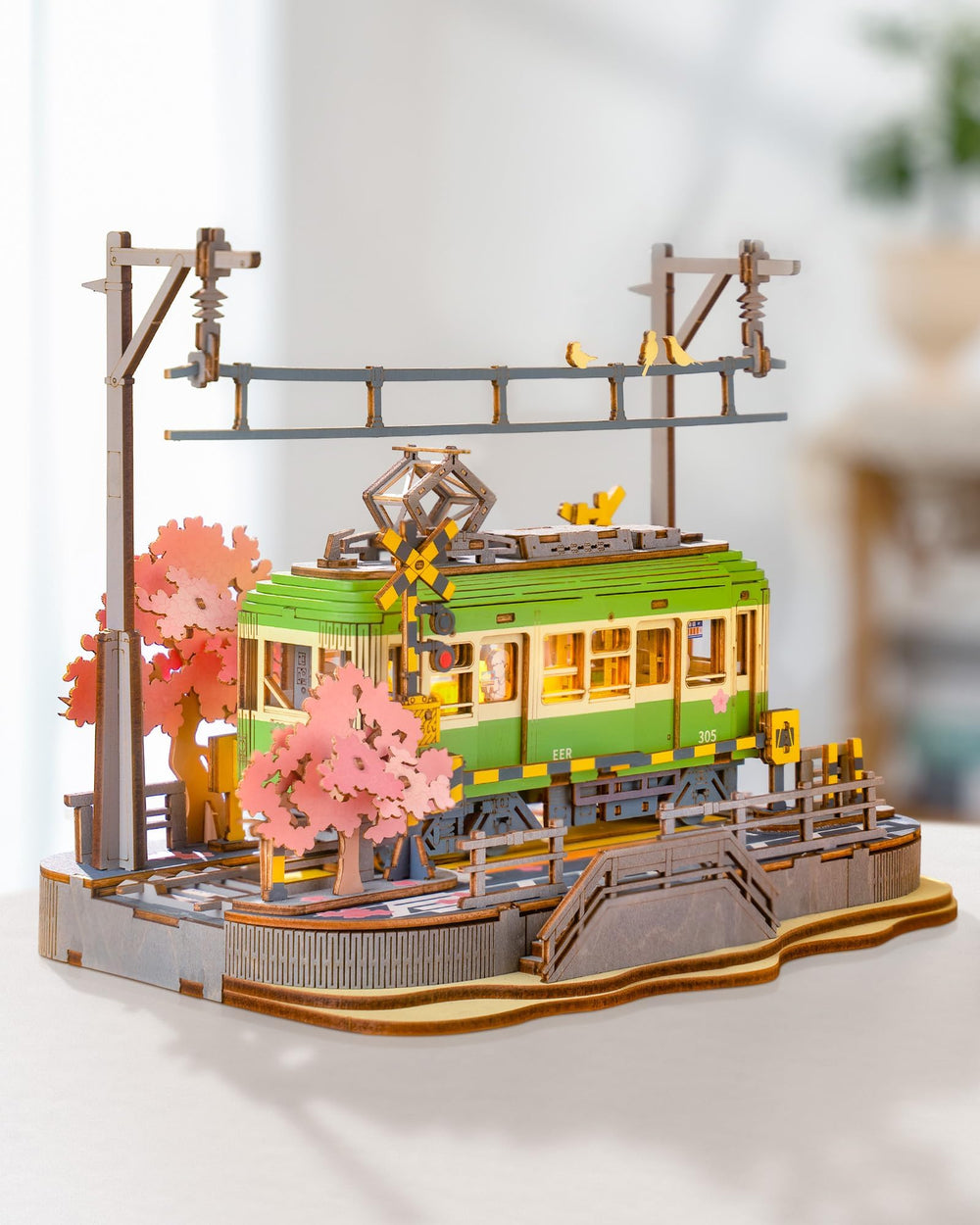 Rolife Sakura Journey Tram lit at night, inspiring storytelling and imagination.
