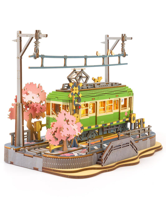 Rolife Sakura Journey Tram with LED lights on a desk, captivating centerpiece.