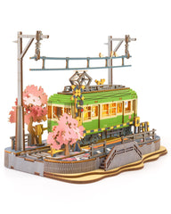 Rolife Sakura Journey Tram with LED lights on a desk, captivating centerpiece.
