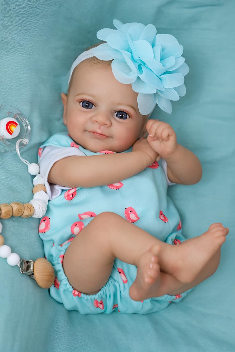 SCOM Flynn play-ready pose with bottle and pacifier in use