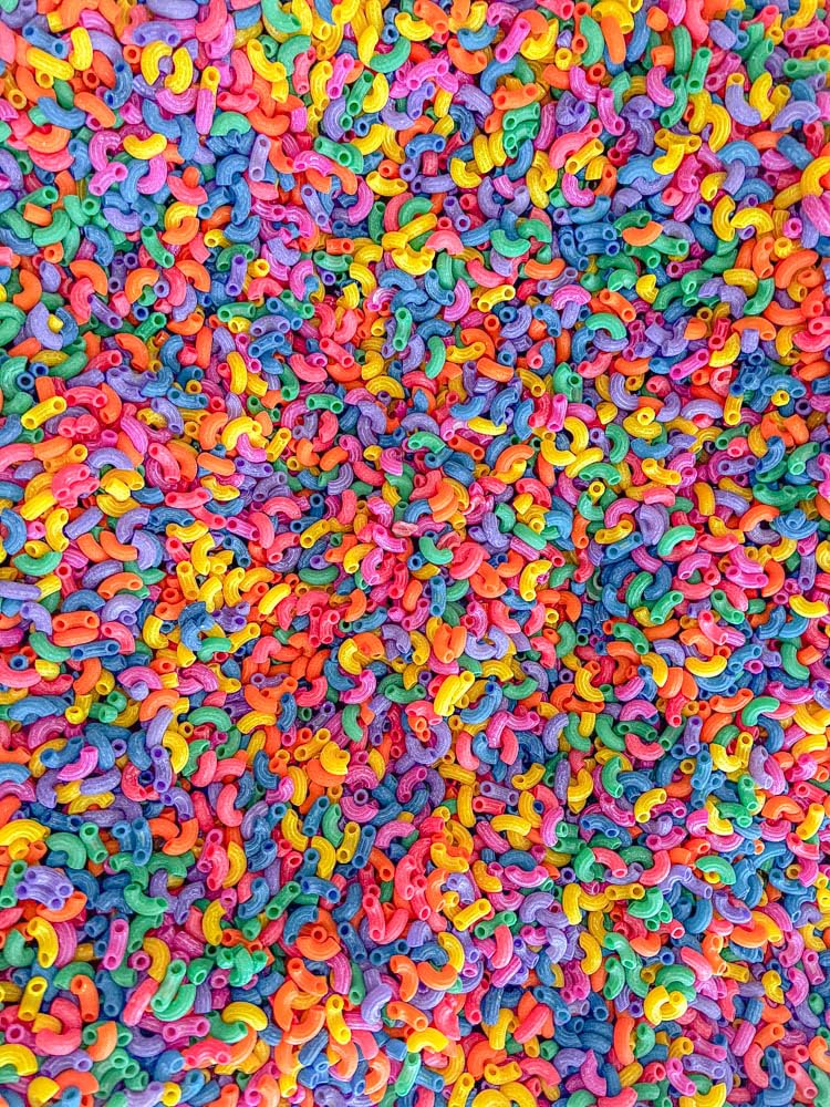 Sensory-N-Stuff color pasta provides a visually engaging focal point for activities.