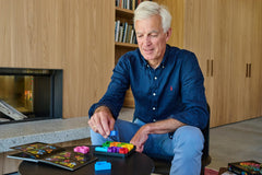 SmartGames IQ Deluxe Square designed for ages 14+ offering deeper logic challenges.