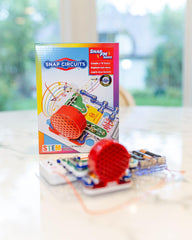 Snap Circuits FM Radio Kit components laid out highlight color-coded modules for hands-on exploration