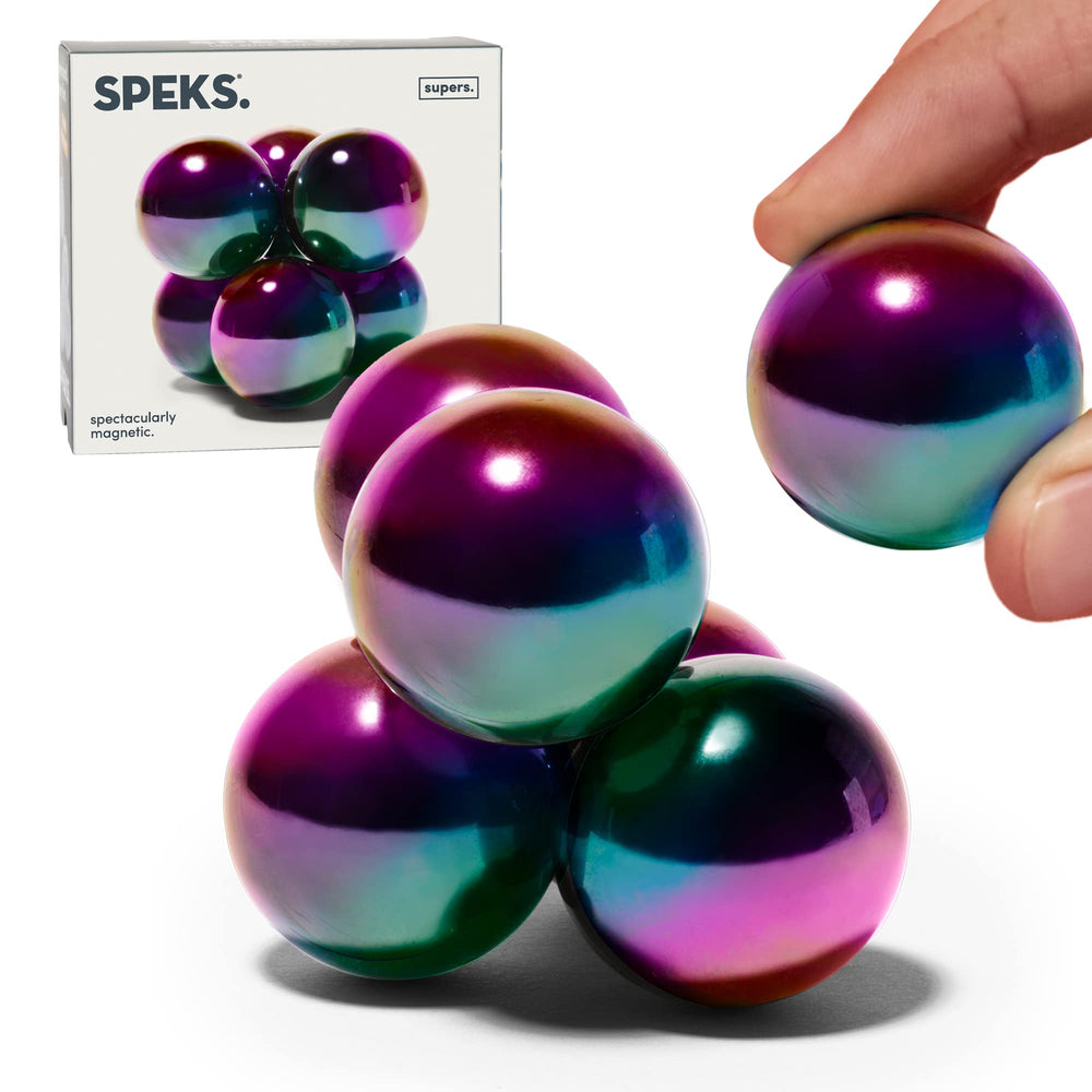 Speks Supers magnetic balls in oil slick finish arranged on a stylish desk for display and focus.