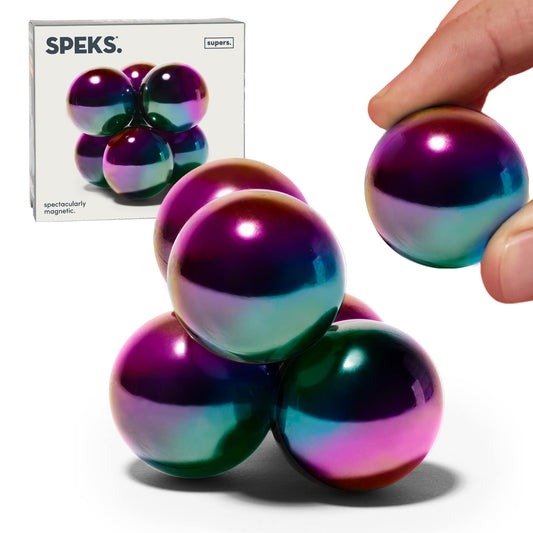 Speks Supers magnetic balls in oil slick finish arranged on a stylish desk for display and focus.