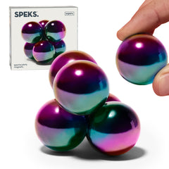 Speks Supers magnetic balls in oil slick finish arranged on a stylish desk for display and focus.