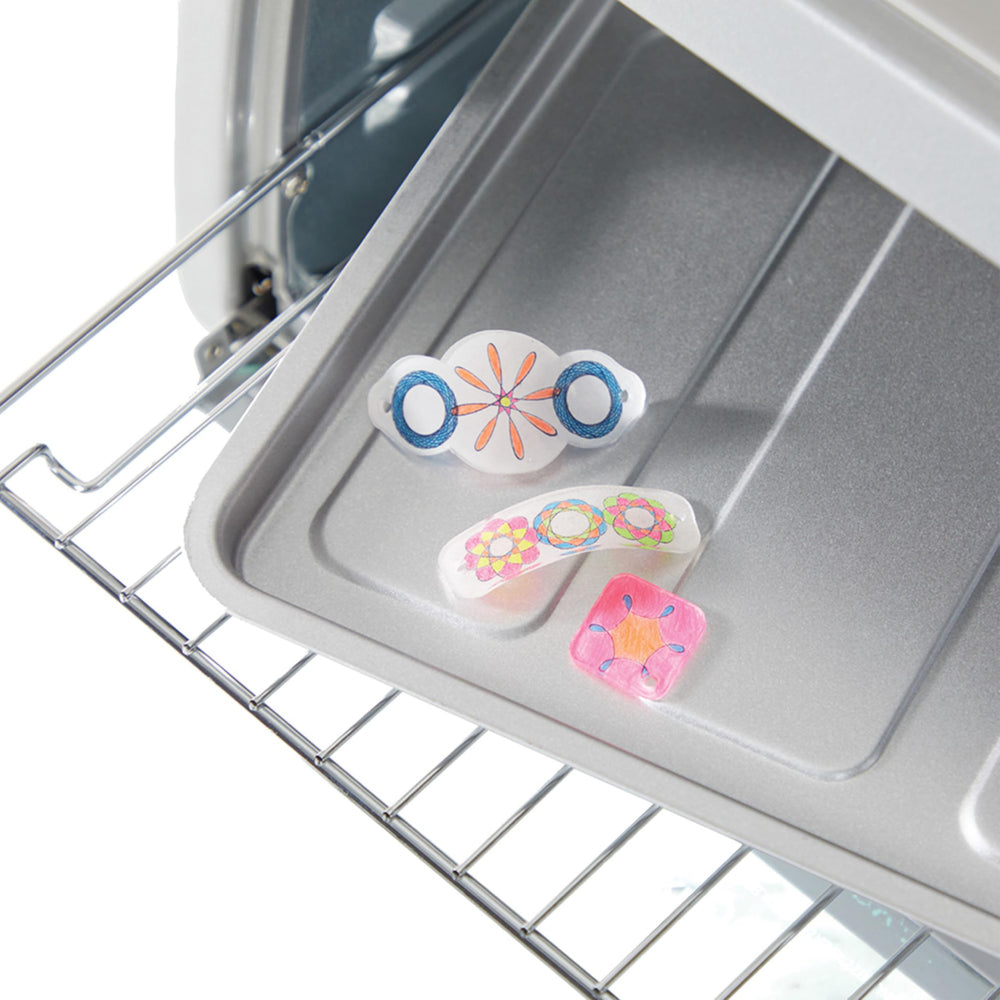 Spirograph Shrink Charms: kids draw spiral art with guidance.